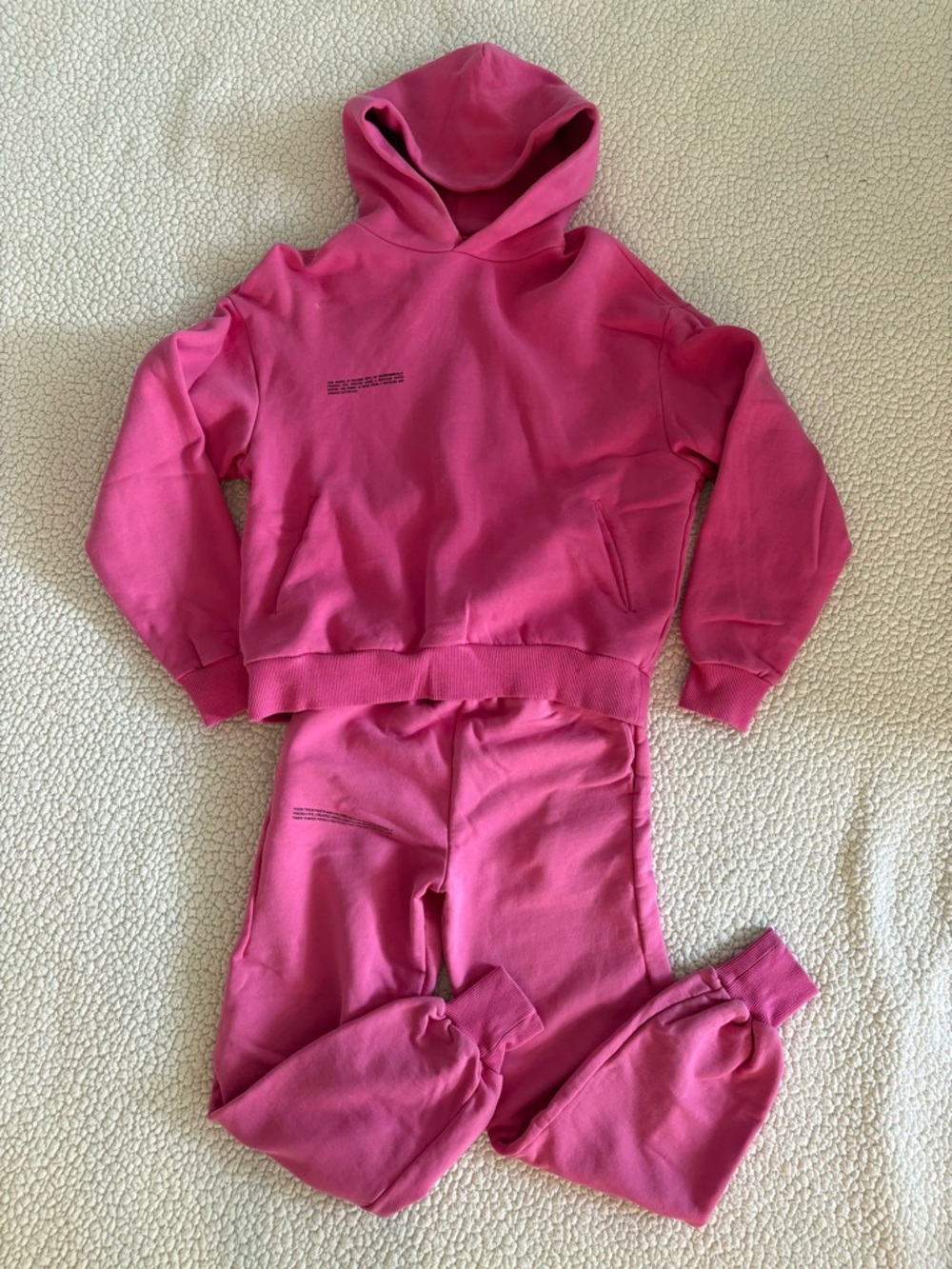 PANGAIA pink matching set including hoodie and jogger sweatpants.